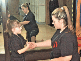 Instructor enters scene with free self-defense class