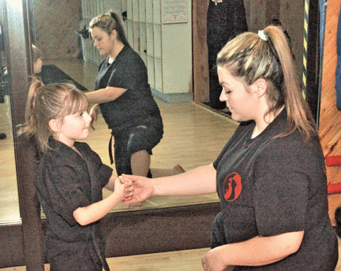 Instructor enters scene with free self-defense class