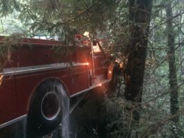 Antique fire truck hits bridge
