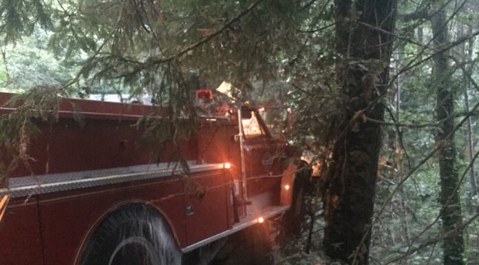 Antique fire truck hits bridge