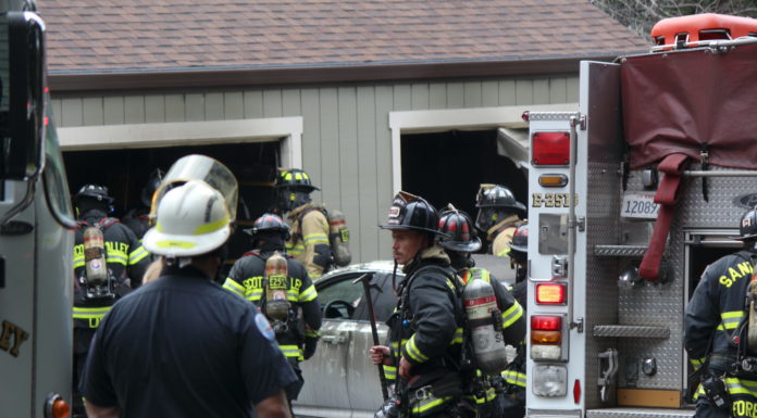 Hidden Oaks Garage Fire Extinguished Quickly holding a tool