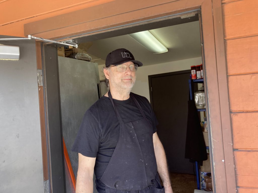 cafe co-owner in the doorway