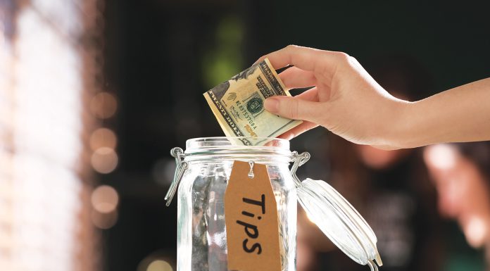 Finance | Itemizing Trump Tax Deductions for 2025 Tip jar with money
