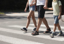 Scotts Valley police launch school safety enforcement Father holding hands with his kids while on pedestrian crossing