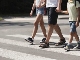 Scotts Valley police launch school safety enforcement Father holding hands with his kids while on pedestrian crossing