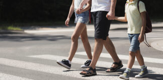 Scotts Valley police launch school safety enforcement Father holding hands with his kids while on pedestrian crossing