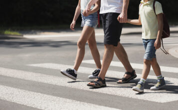 Scotts Valley police launch school safety enforcement Father holding hands with his kids while on pedestrian crossing