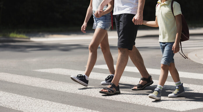 Scotts Valley police launch school safety enforcement Father holding hands with his kids while on pedestrian crossing