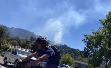 UPDATED: Scotts Valley vegetation fire under control, police investigating tip about homeless encampment smoke in the background