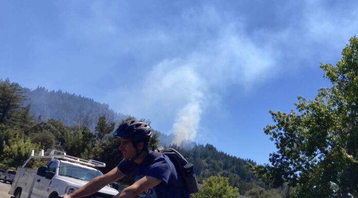 UPDATED: Scotts Valley vegetation fire under control, police investigating tip about homeless encampment smoke in the background